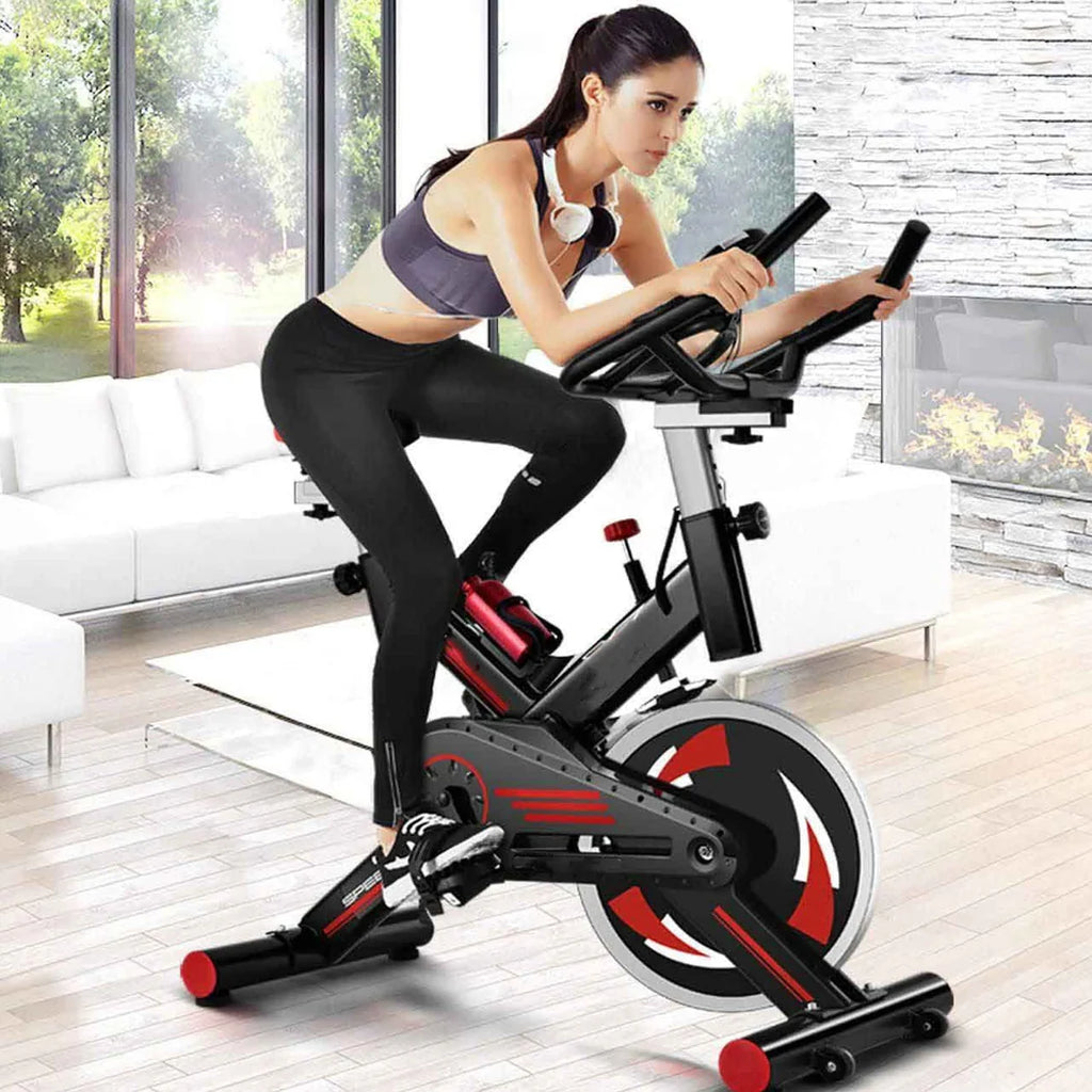 Woman exercising on a stationary bike in a modern living room.