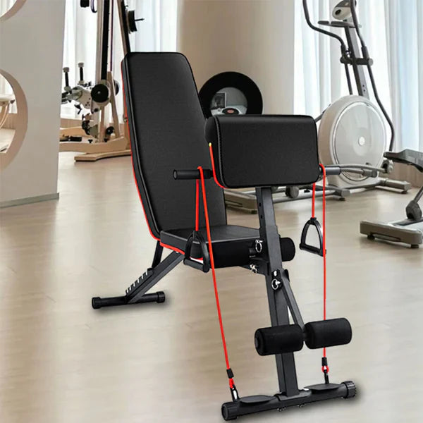 Black adjustable weight bench with red straps in a gym setting
