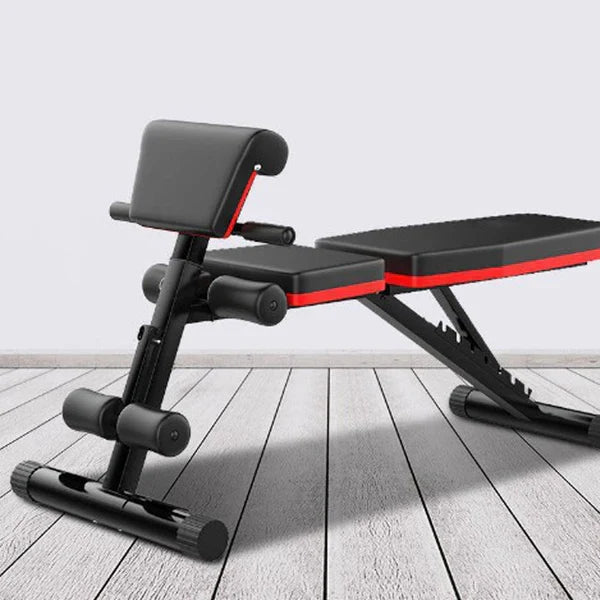 Adjustable weight bench on a wooden floor with a light gray background