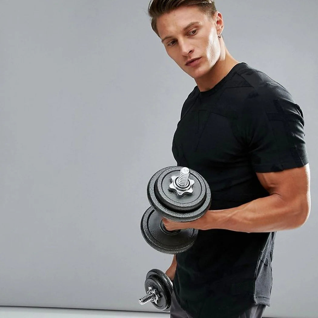Man holding a dumbbell against a gray background