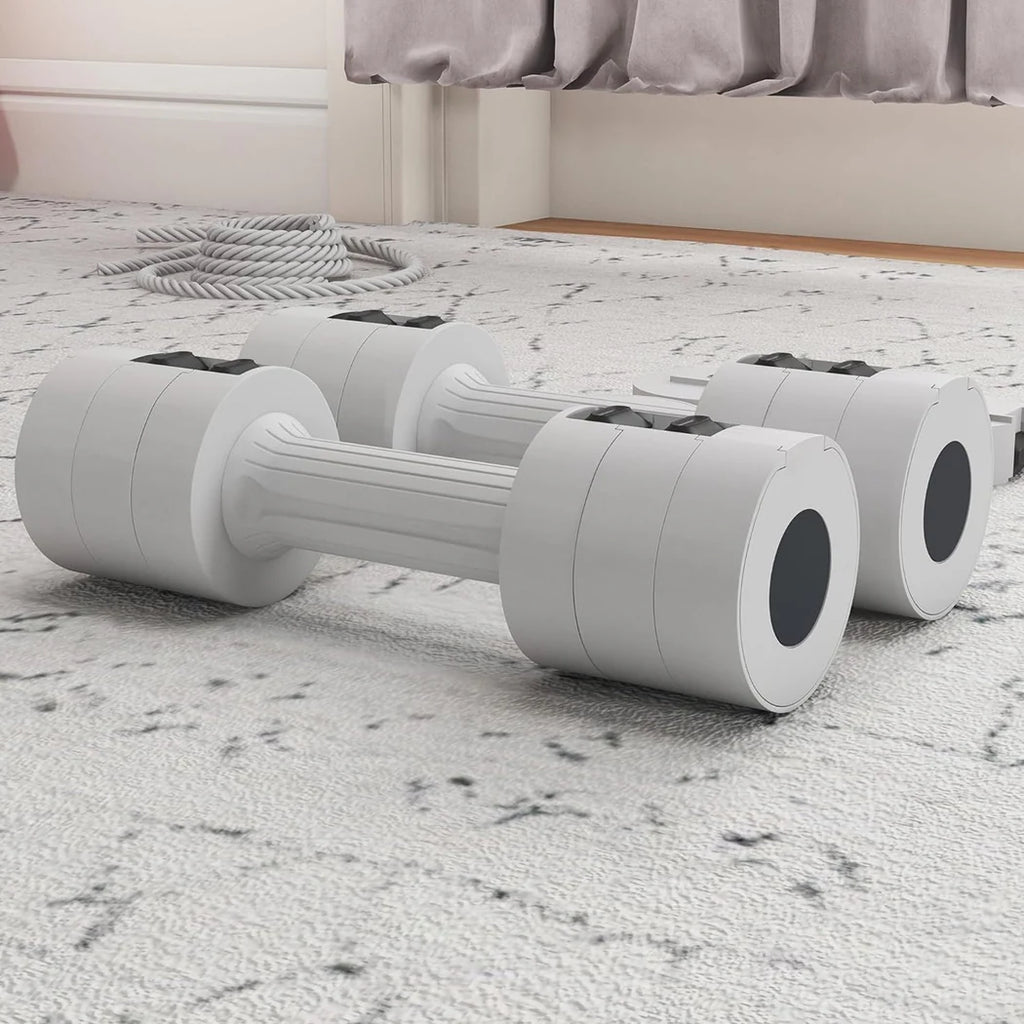 White dumbbells on a carpeted floor with a bed in the background