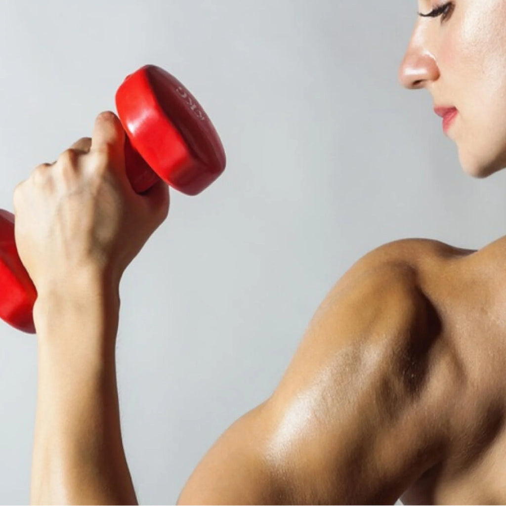 Person lifting a red dumbbell against a gray background