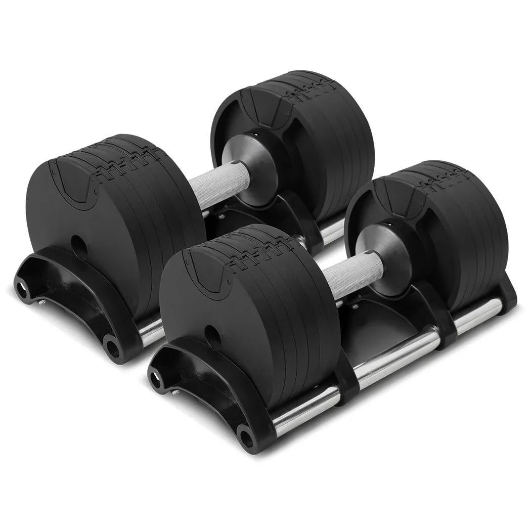 Set of adjustable dumbbells on a white background