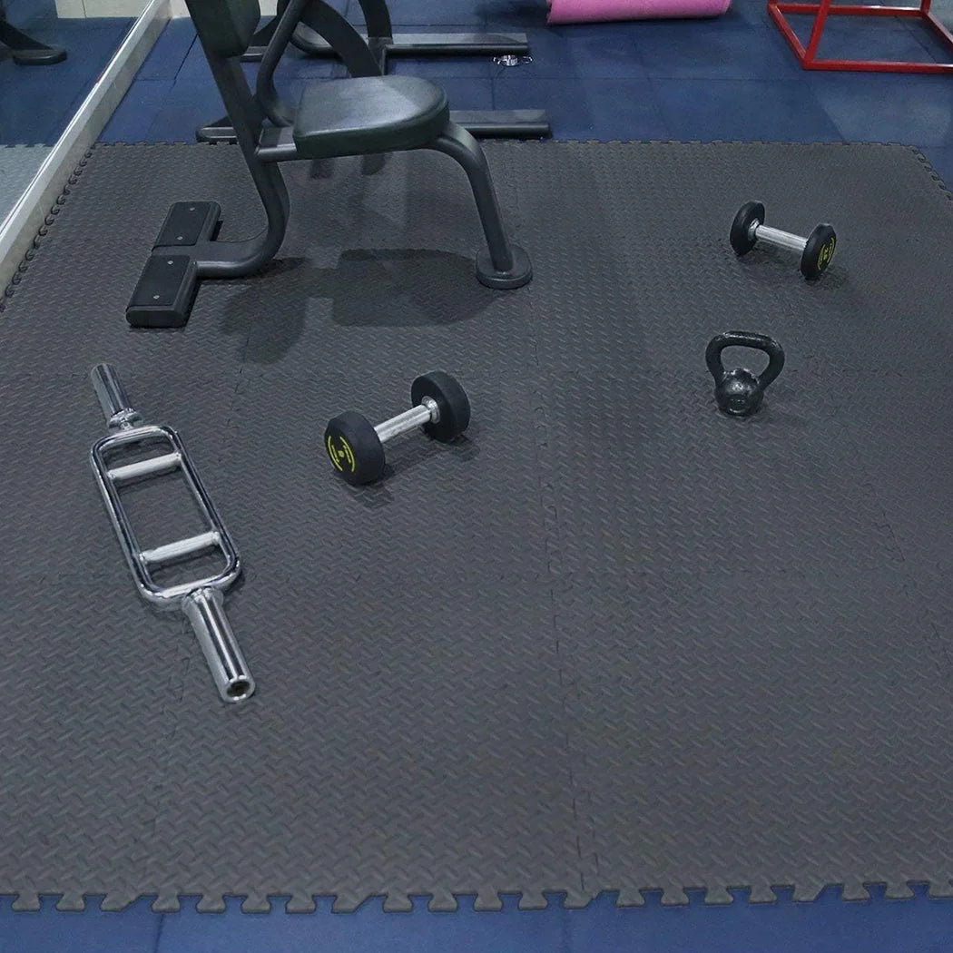 Gym floor with exercise equipment on a black mat