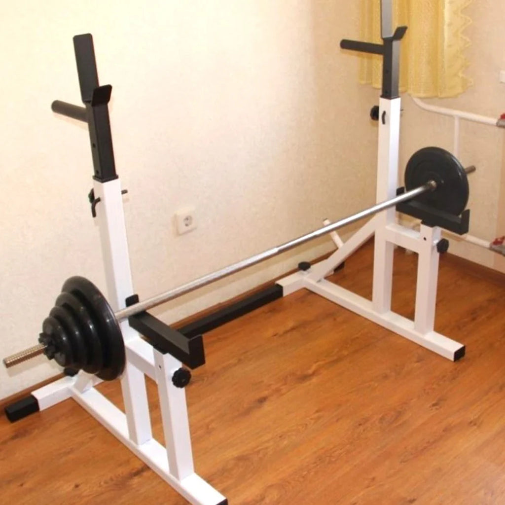 White weight bench with barbell on a wooden floor