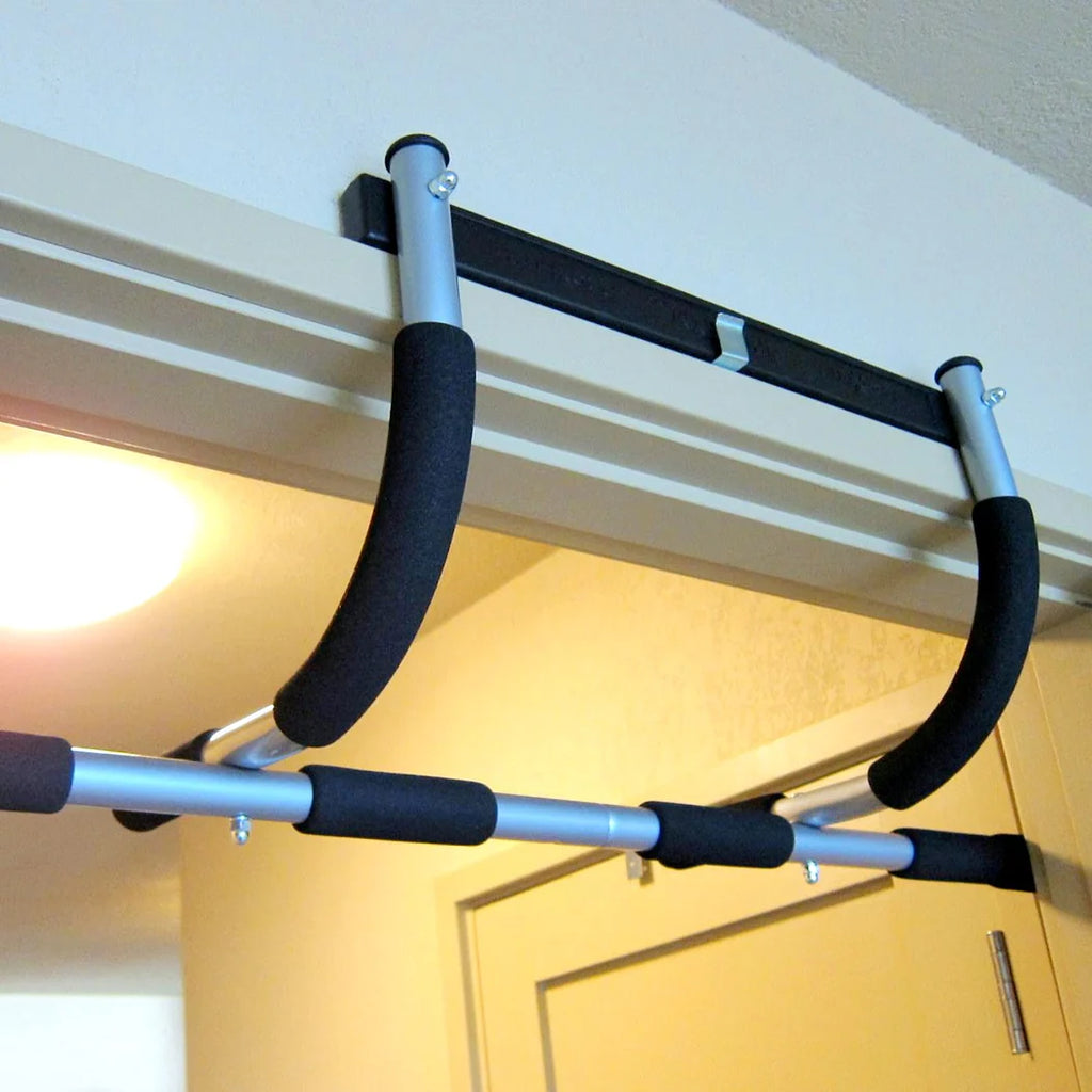 Doorway pull-up bar attached to a door frame with a light source in the background.