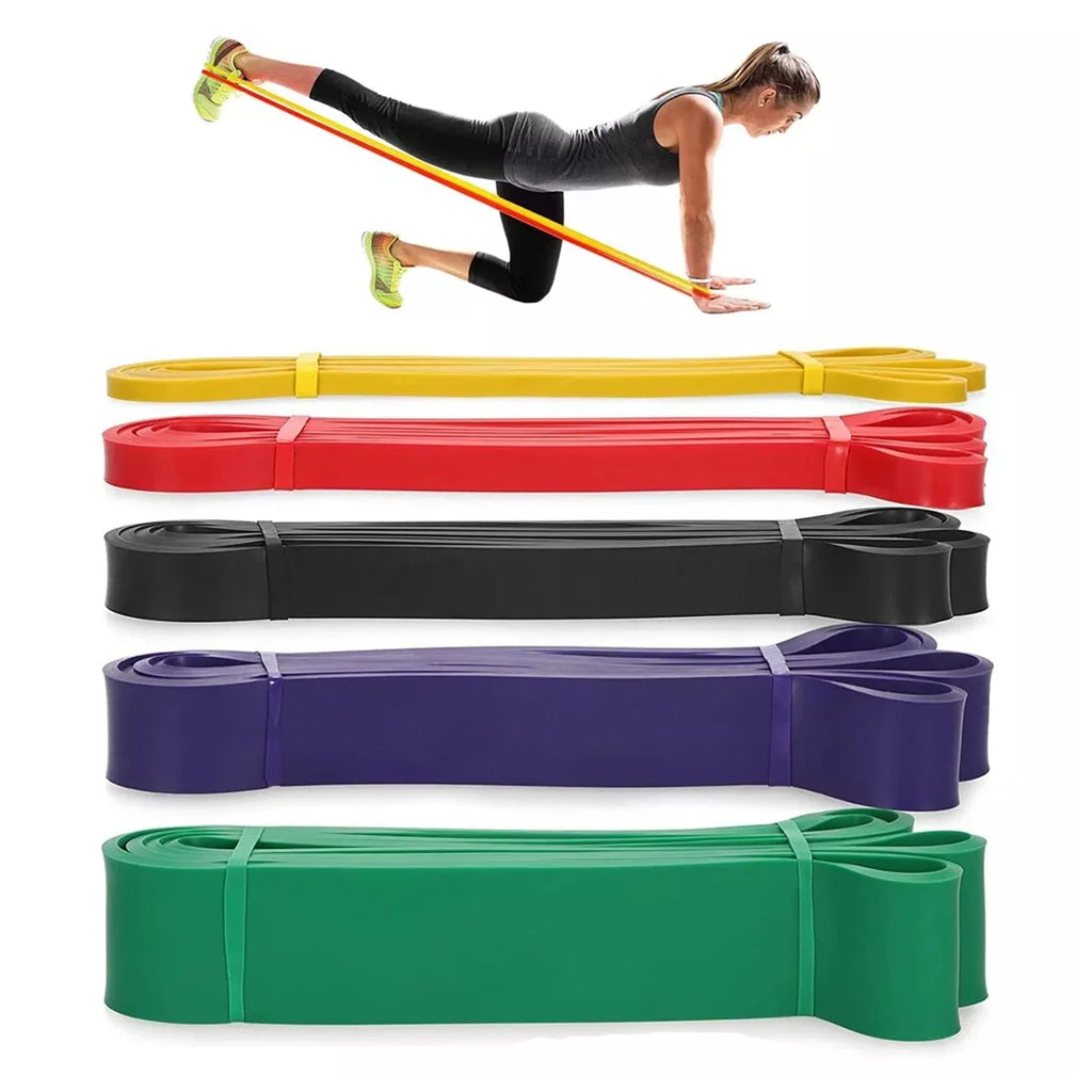 Resistance bands in various colors with a woman exercising on a white background