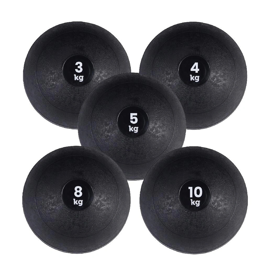 Five black slam balls with weight labels on a white background