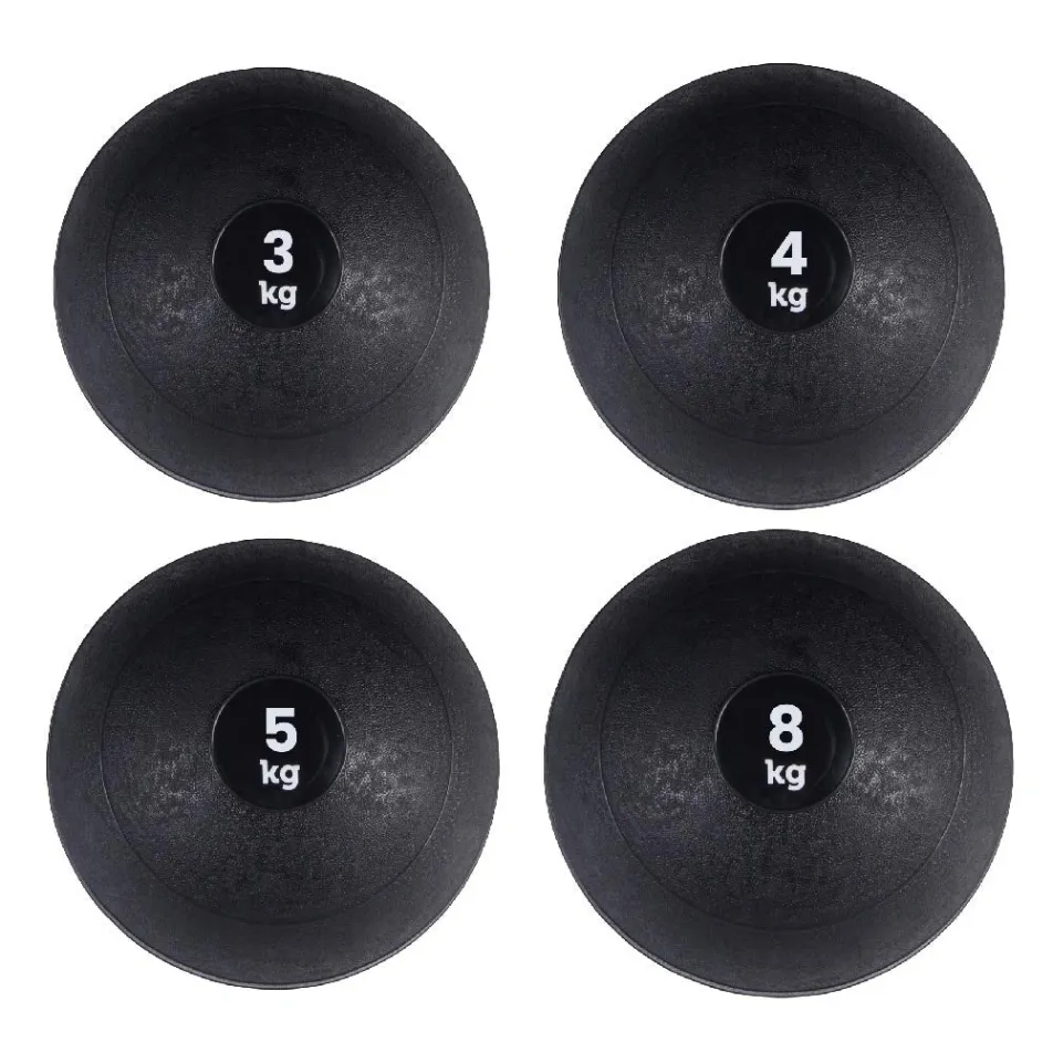 Four black slam balls with weight markings on a white background