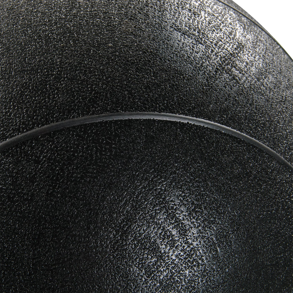 Close-up of a textured black surface with a curved line