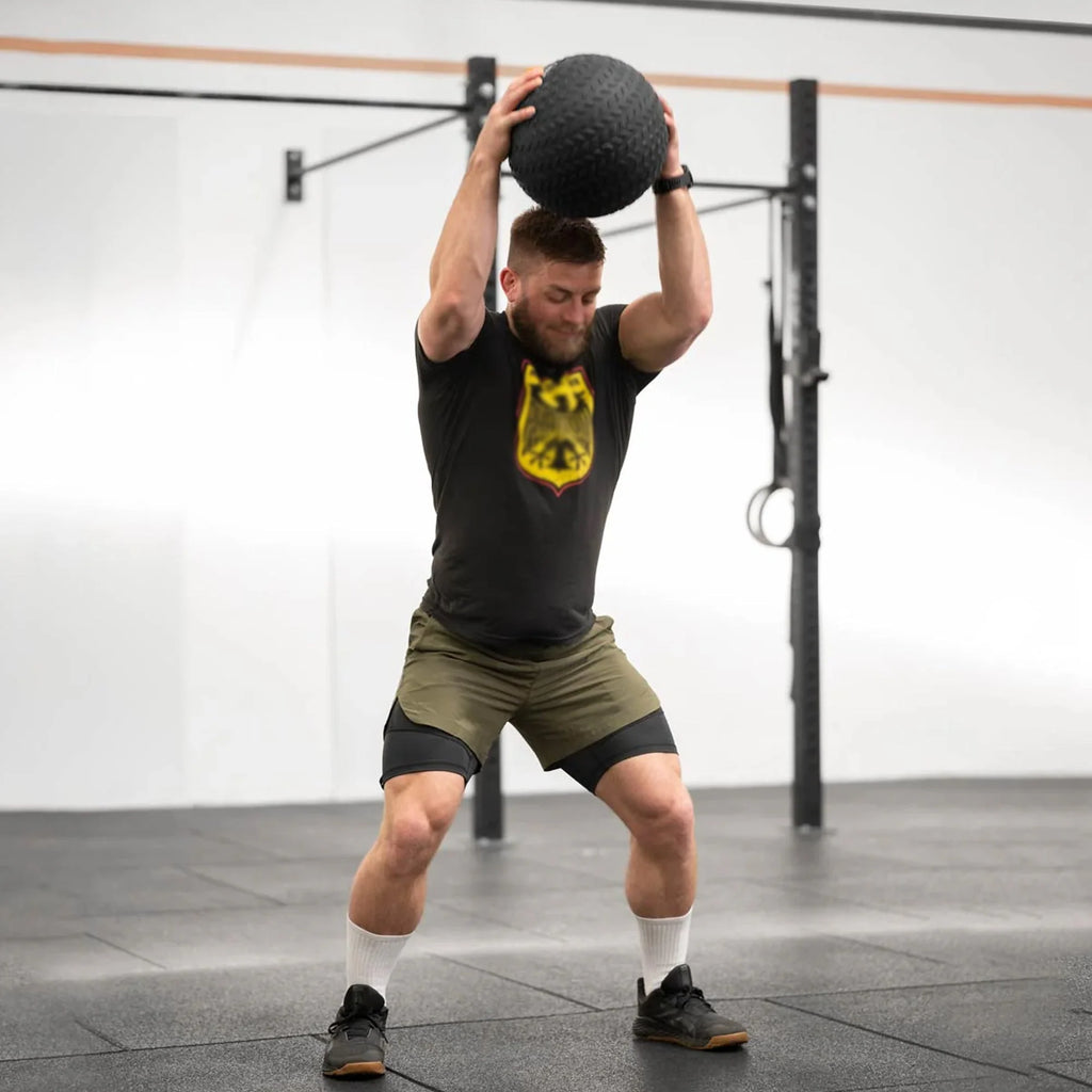 Man exercising with a medicine ball in a gym setting
