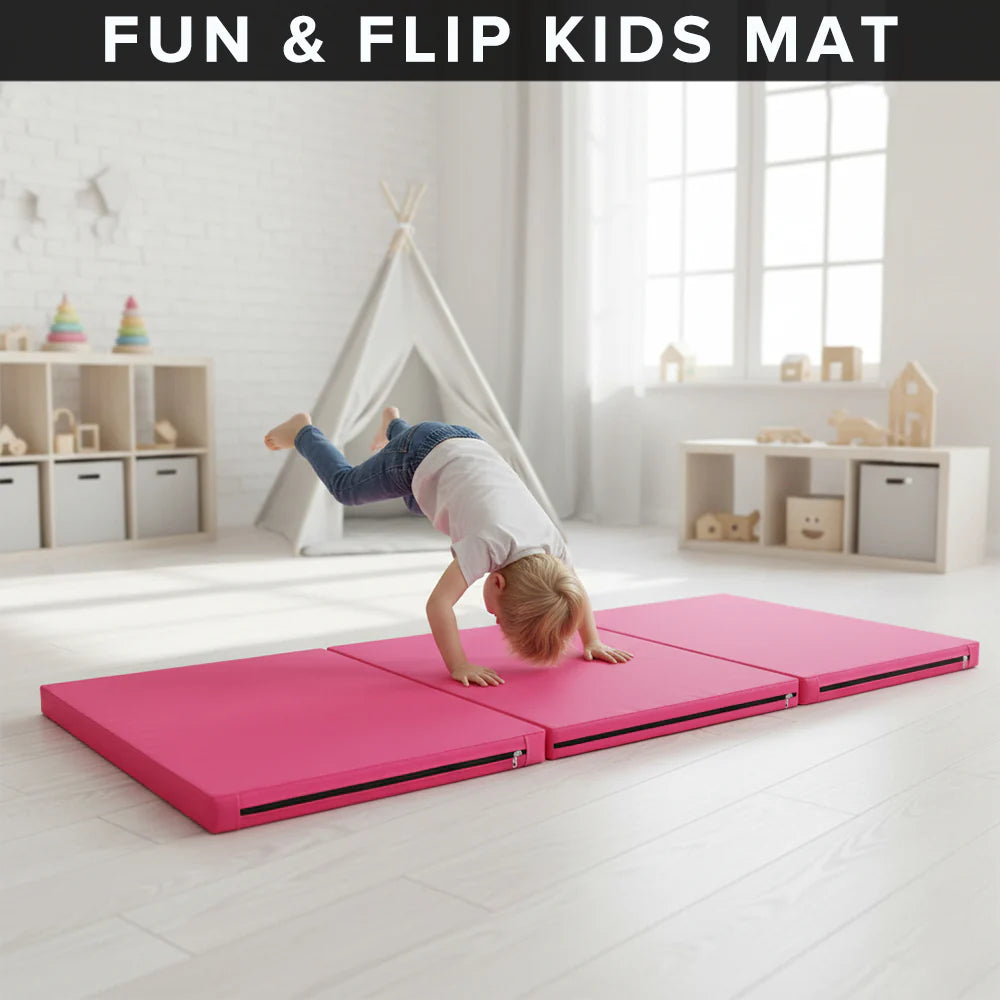 Pink kids mat with child doing a handstand in a bright room.