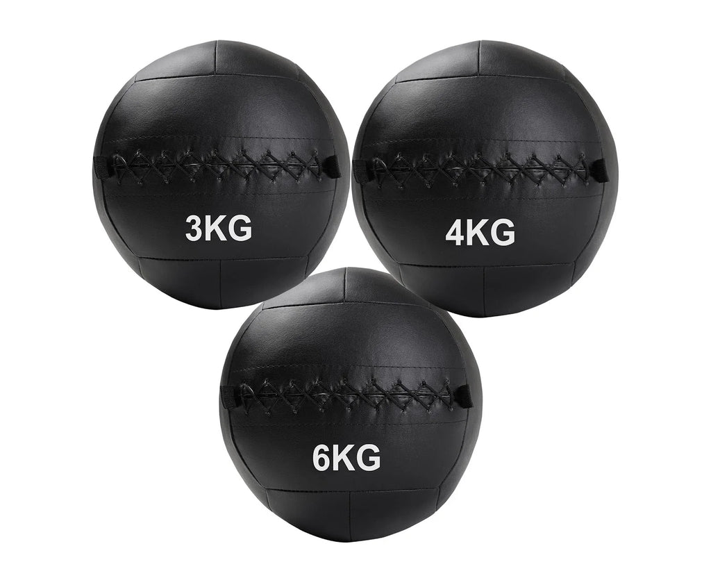 Three black wall balls with weight labels on a white background