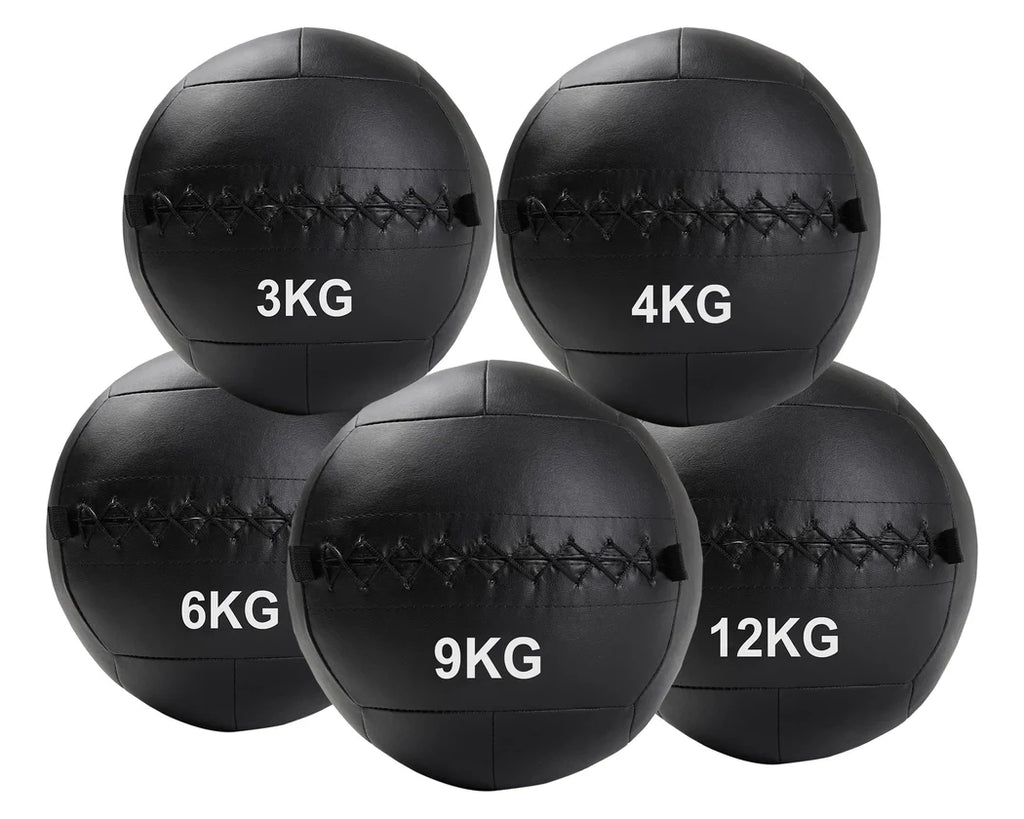 Set of black weighted medicine balls with labeled weights on a white background