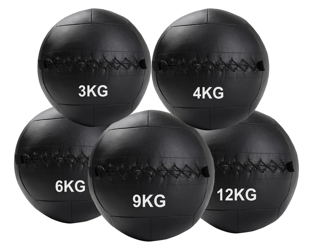 Set of black weighted medicine balls with labeled weights on a white background
